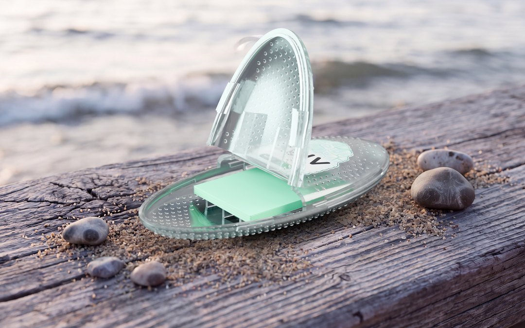 Open SLIV case on driftwood by the lake, with mint strips inside