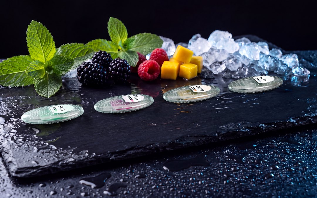 Four SLIV cases on slate with mint, berries, mango and ice
